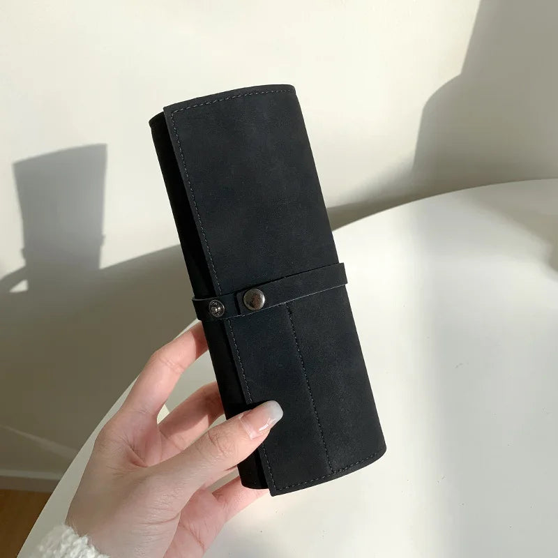 Five-slot PU strap organizer roll shown in black
